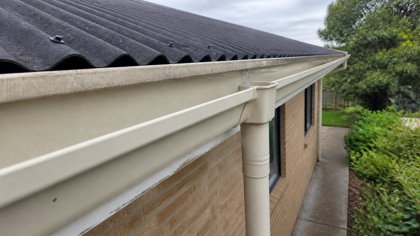 Clean cream gutter being water-tested after a Waikato gutter clean