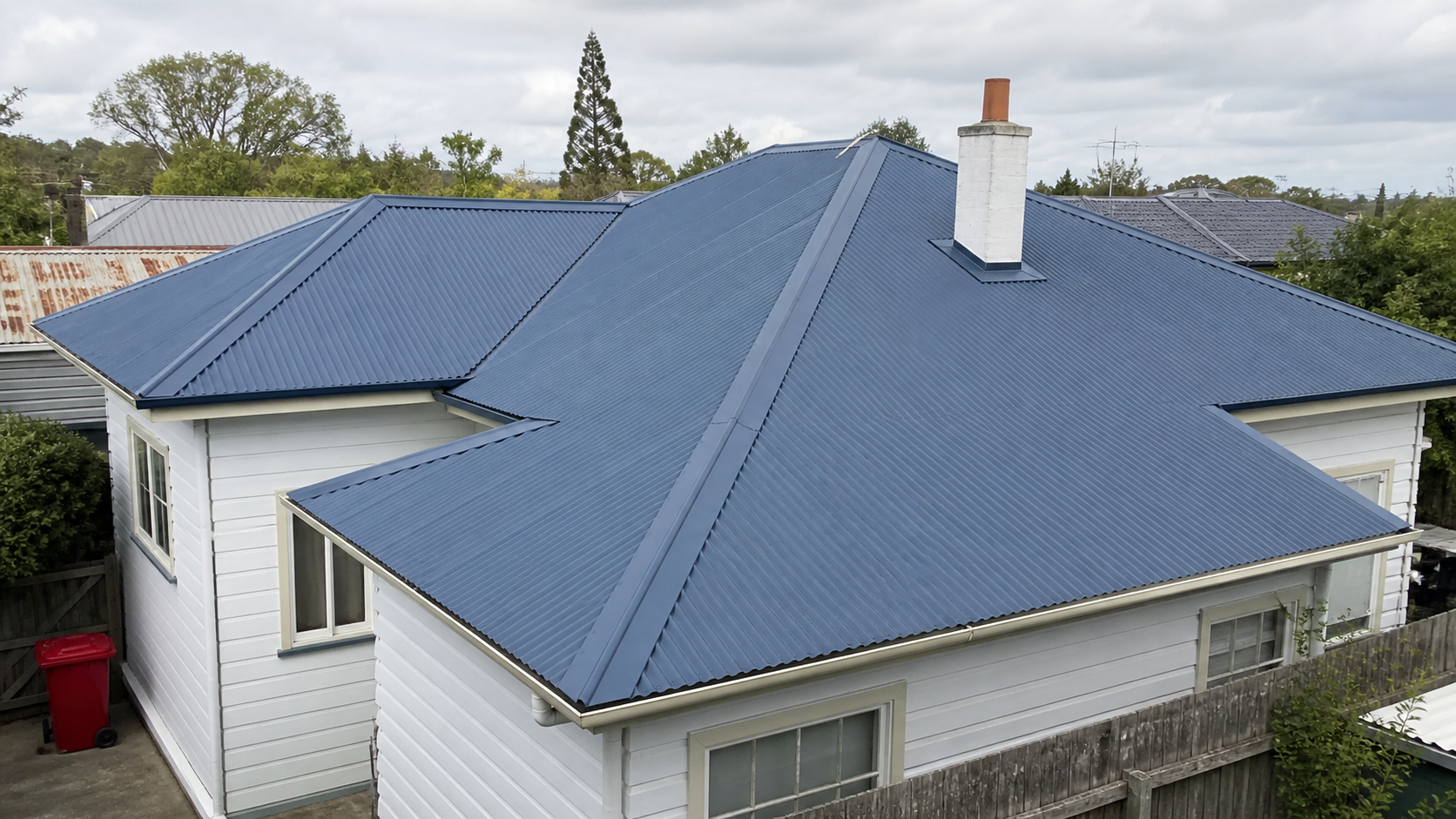 Fresh deep blue roof coating on a Hamilton weatherboard home